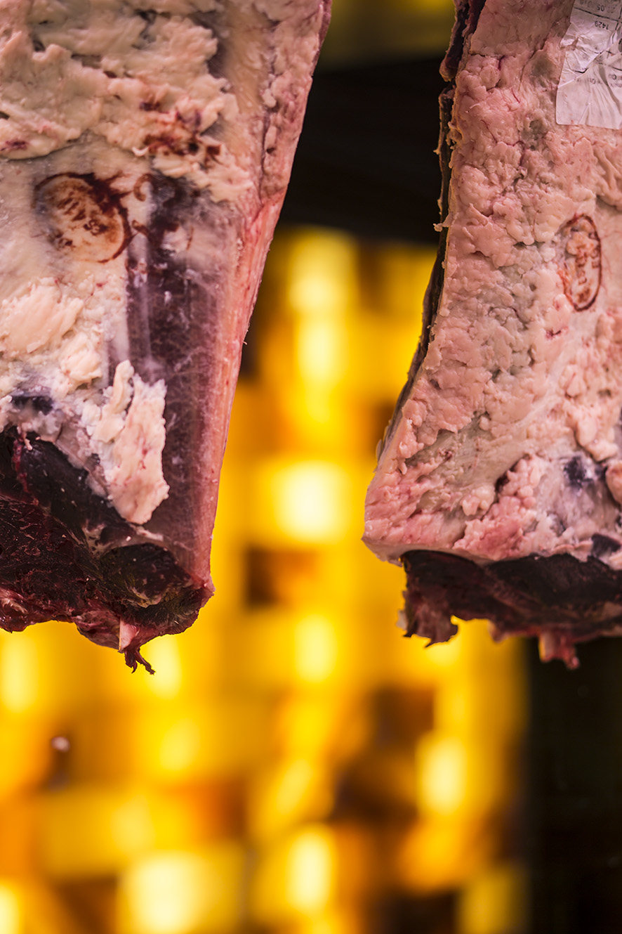 The Aging Room. Premium Meat Dry-Aging Walk Chamber. Meat in front of the wall of real pink Himalayan salt.