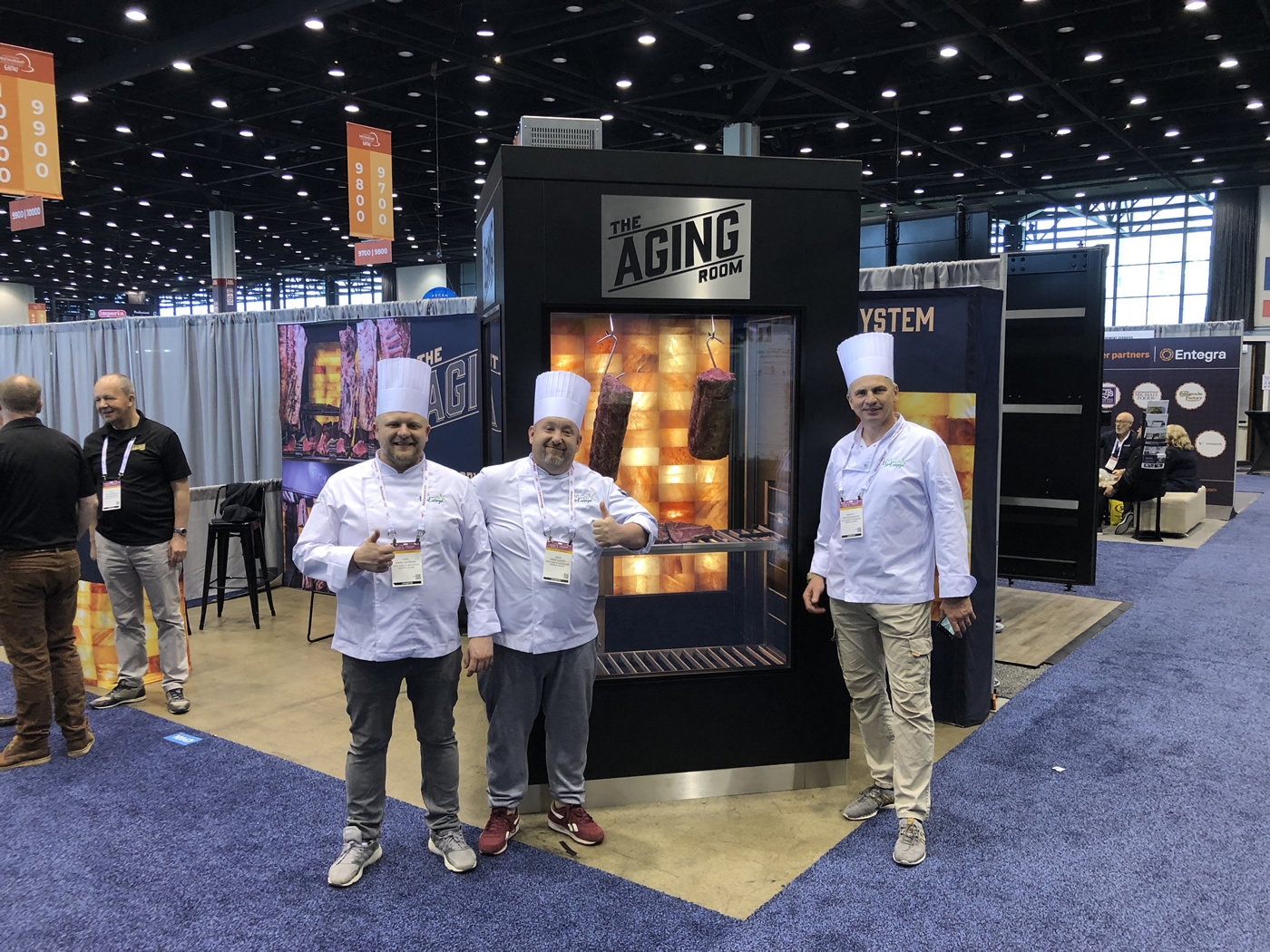 The Aging Room. NRA Show 2022. Chefs in front of the walk-in Chamber.